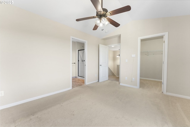 381 SE Regan Hill Loop, Estacada, OR 97023 - unfurnished bedroom with lofted ceiling, a walk in closet, light colored carpet, a closet, and ceiling fan