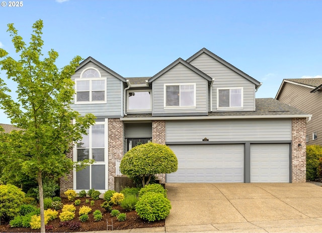 16205 SW Blackbird Dr, Beaverton, OR 97007 - view of front of house with concrete driveway, brick siding, and a shingled roof