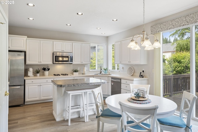 16205 SW Blackbird Dr, Beaverton, OR 97007 - kitchen with appliances with stainless steel finishes, a sink, recessed lighting, healthy amount of natural light, and a chandelier