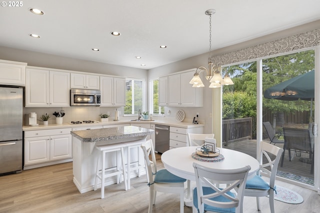 16205 SW Blackbird Dr, Beaverton, OR 97007 - kitchen featuring stainless steel appliances, recessed lighting, a sink, healthy amount of natural light, and a kitchen island