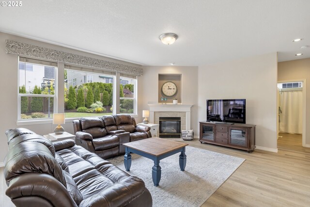 16205 SW Blackbird Dr, Beaverton, OR 97007 - living area with light wood-style floors, baseboards, a tile fireplace, and recessed lighting