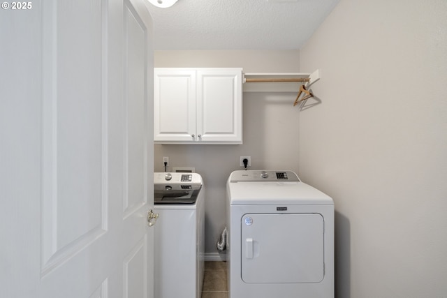 16205 SW Blackbird Dr, Beaverton, OR 97007 - laundry area featuring washer and dryer, cabinet space, a textured ceiling, and tile patterned floors