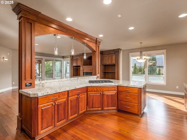 dining room with a wealth of natural light, a chandelier, and light wood-type flooring