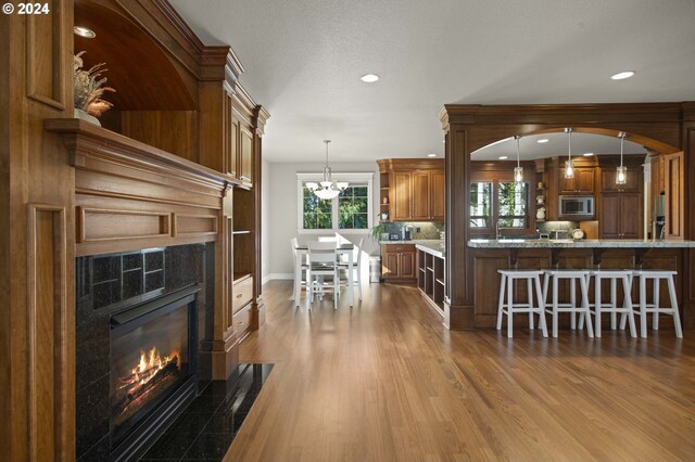 dining room with a notable chandelier, wood-type flooring, and crown molding