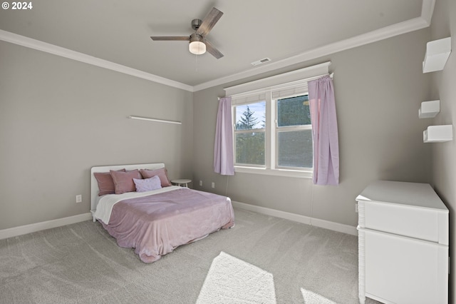 carpeted bedroom featuring ceiling fan and ornamental molding