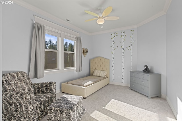 sitting room with light carpet, ceiling fan, and crown molding