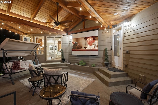 cinema featuring vaulted ceiling with beams, ceiling fan, wood walls, and wood ceiling