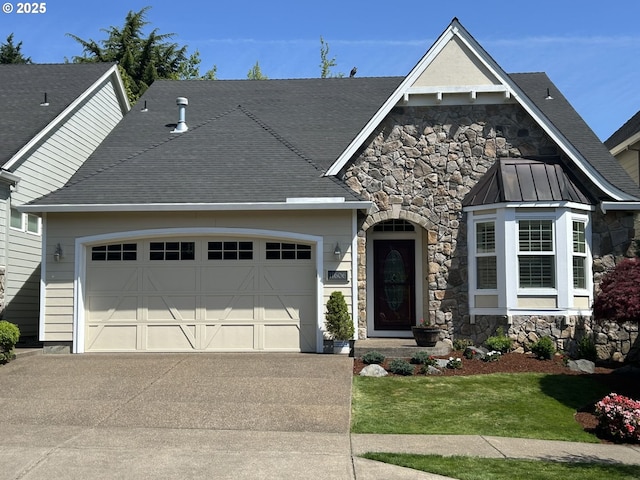 11606 SE Aerie Crescent Rd, Happy Valley, OR 97086 - view of front of house with stone siding, an attached garage, driveway, and roof with shingles