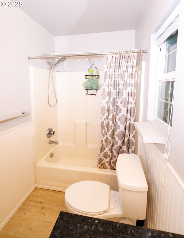 3020 SE 90th Pl, Portland, OR 97266 - bathroom with toilet, wood finished floors, shower / bathtub combination with curtain, and a wainscoted wall