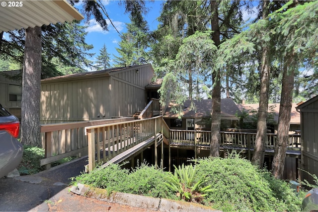202 Trailside Loop, Eugene, OR 97405 - rear view of house featuring board and batten siding and a wooden deck