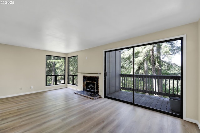 202 Trailside Loop, Eugene, OR 97405 - unfurnished living room featuring wood finished floors and a stone fireplace
