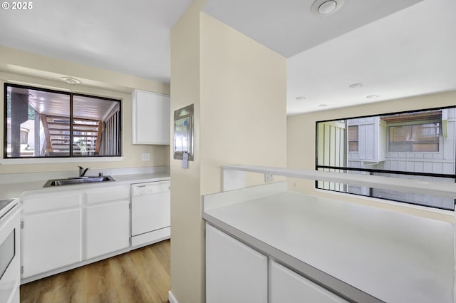 202 Trailside Loop, Eugene, OR 97405 - kitchen featuring white dishwasher, light wood finished floors, white cabinetry, and light countertops