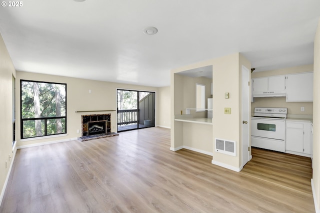 202 Trailside Loop, Eugene, OR 97405 - unfurnished living room featuring light wood-type flooring and a fireplace