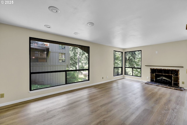 202 Trailside Loop, Eugene, OR 97405 - unfurnished living room with wood finished floors, a stone fireplace, and recessed lighting