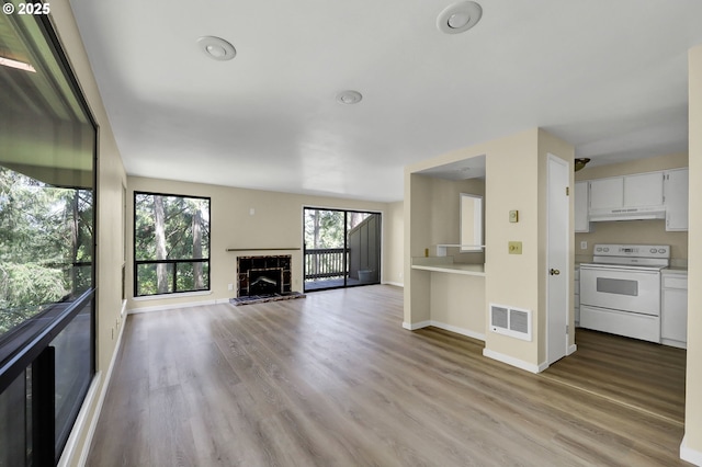 202 Trailside Loop, Eugene, OR 97405 - unfurnished living room featuring light wood-style floors and a fireplace