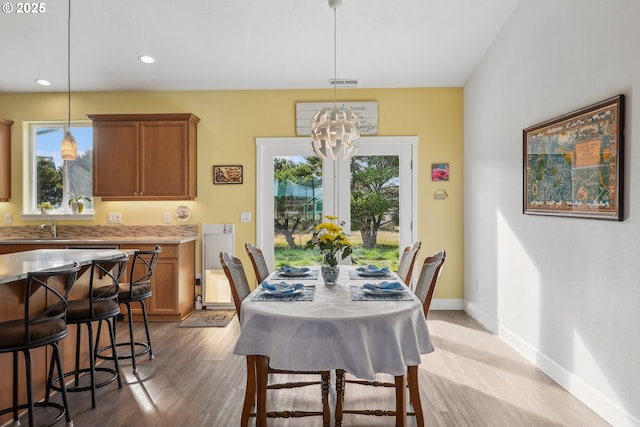 dining area featuring recessed lighting, a notable chandelier, a wealth of natural light, and visible vents