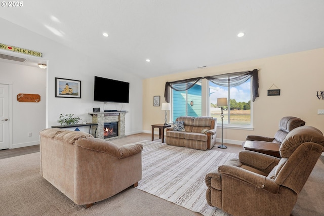 living room featuring lofted ceiling and a fireplace