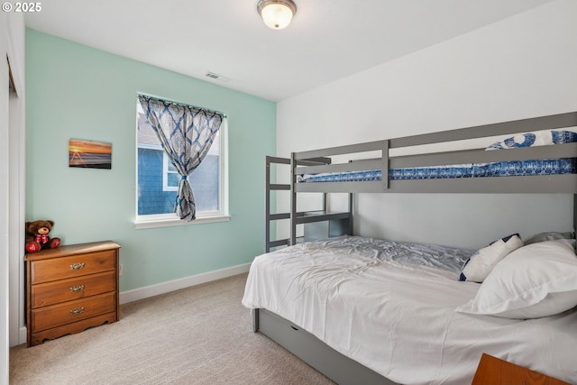 bedroom featuring light colored carpet