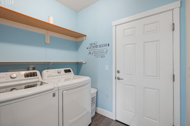 clothes washing area featuring baseboards, laundry area, dark wood-type flooring, and washer and dryer