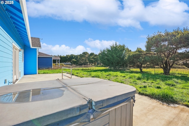 view of patio featuring a rural view and a hot tub