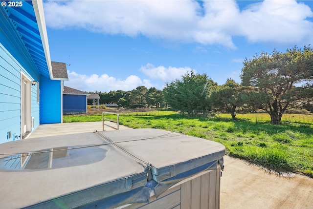 exterior space with a hot tub and a patio area