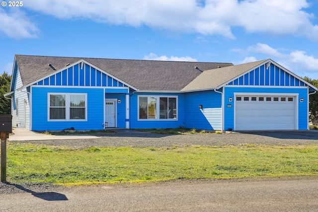 view of front of house with a garage and a front lawn