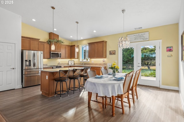 dining area with visible vents, baseboards, dark wood-style floors, and an inviting chandelier