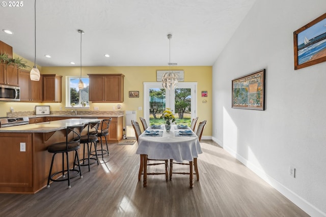 dining room with recessed lighting, baseboards, dark wood finished floors, and an inviting chandelier