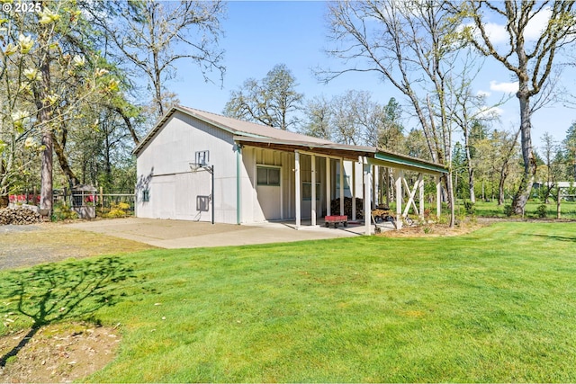 rear view of property featuring a yard and a patio