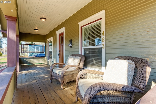 wooden terrace featuring covered porch