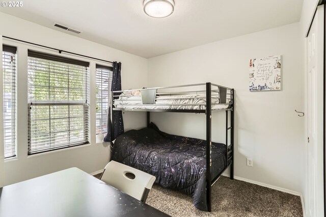 bedroom featuring carpet floors, baseboards, and visible vents