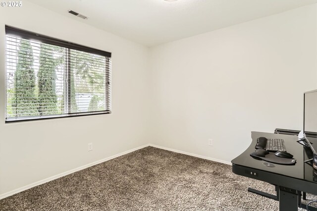 carpeted home office with baseboards and visible vents
