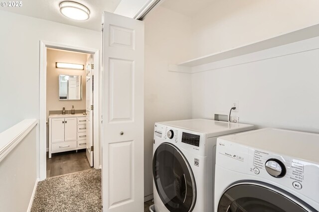 laundry area with washing machine and clothes dryer, laundry area, and a sink