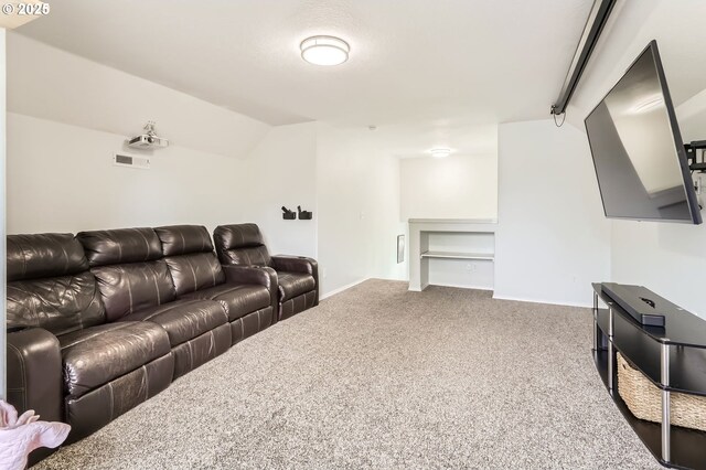carpeted living area with baseboards, lofted ceiling, and visible vents