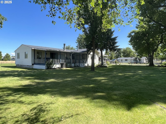 back of property with a porch, crawl space, and a yard