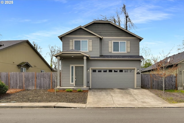 view of front of property featuring an attached garage, fence, and driveway