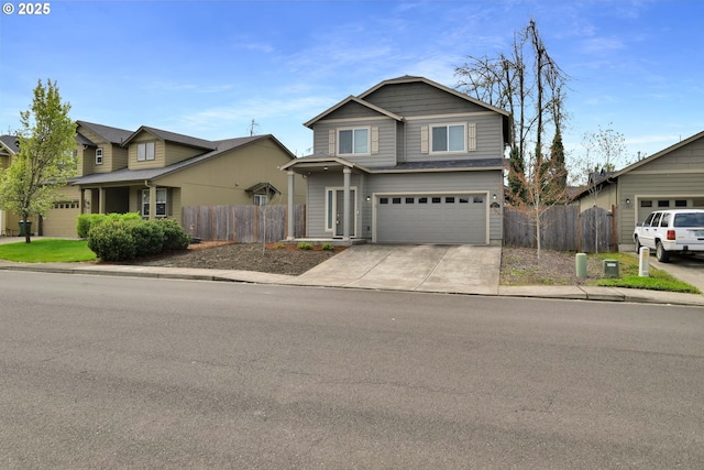 traditional-style house featuring an attached garage, fence, and driveway