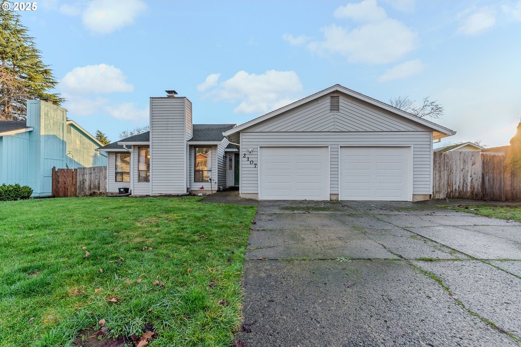 ranch-style house with a front yard and a garage