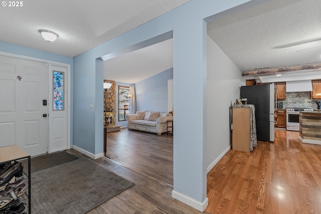 entryway featuring a textured ceiling and light wood-type flooring