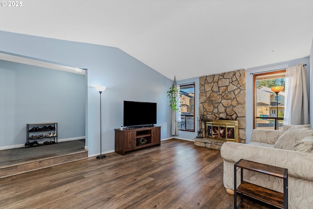 living room featuring dark hardwood / wood-style floors, lofted ceiling, and a fireplace