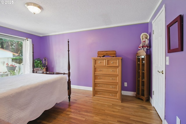 14996 SE Caruthers Ct, Portland, OR 97233 - bedroom featuring a textured ceiling and light wood-type flooring