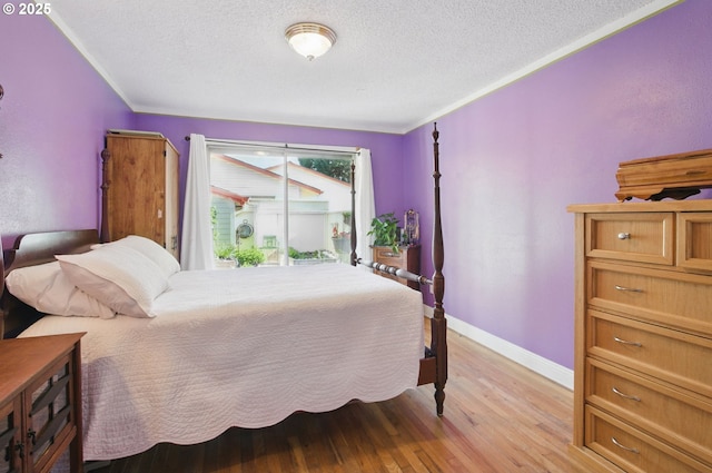 14996 SE Caruthers Ct, Portland, OR 97233 - bedroom with a textured ceiling, light wood finished floors, and crown molding