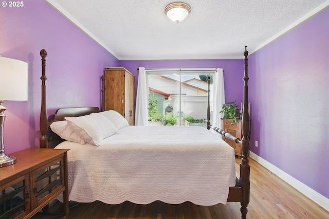 14996 SE Caruthers Ct, Portland, OR 97233 - bedroom with light wood finished floors, a textured ceiling, and crown molding