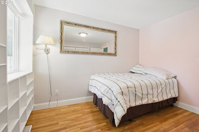 14996 SE Caruthers Ct, Portland, OR 97233 - bedroom with wood finished floors and a textured ceiling