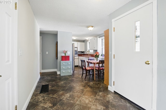 14996 SE Caruthers Ct, Portland, OR 97233 - entrance foyer featuring a textured ceiling and stone finish floors