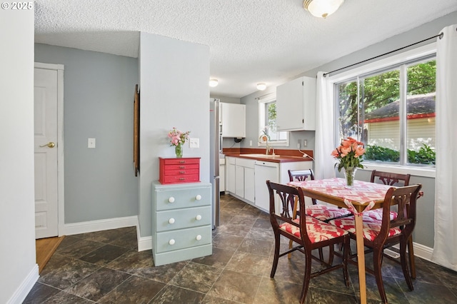 14996 SE Caruthers Ct, Portland, OR 97233 - dining area with a textured ceiling and dark stone finish floors