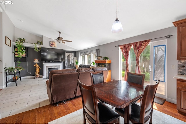 185 Lynx Ave, Aumsville, OR 97325 - dining space featuring vaulted ceiling, ceiling fan, a fireplace, and light wood finished floors