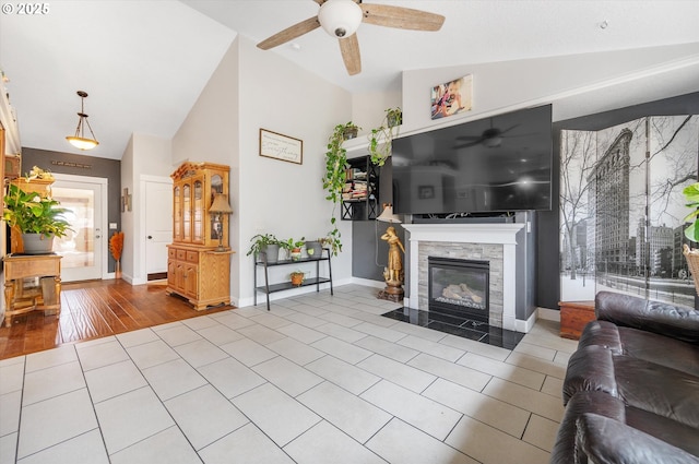 185 Lynx Ave, Aumsville, OR 97325 - living area with ceiling fan, a tile fireplace, and high vaulted ceiling