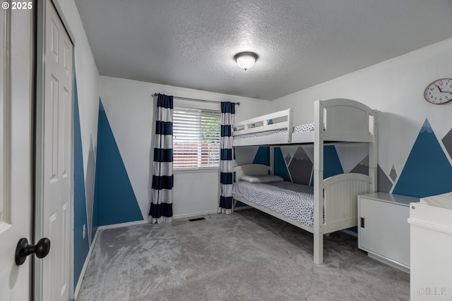 7364 SW 175th Ter, Beaverton, OR 97007 - carpeted bedroom with a textured ceiling, baseboards, and a closet
