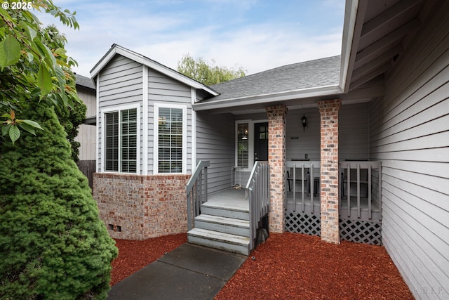 7364 SW 175th Ter, Beaverton, OR 97007 - view of exterior entry featuring brick siding, a shingled roof, a porch, and crawl space